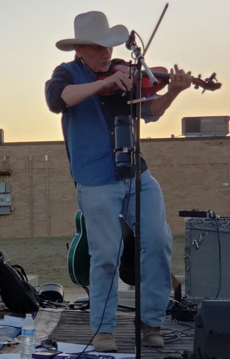 Mark Wayne Hagood playing fiddle outdoors